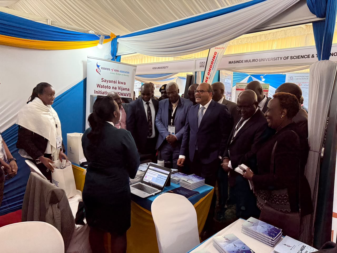 SCOKA members presenting at a science exhibition booth, engaging stakeholders with university partners nearby